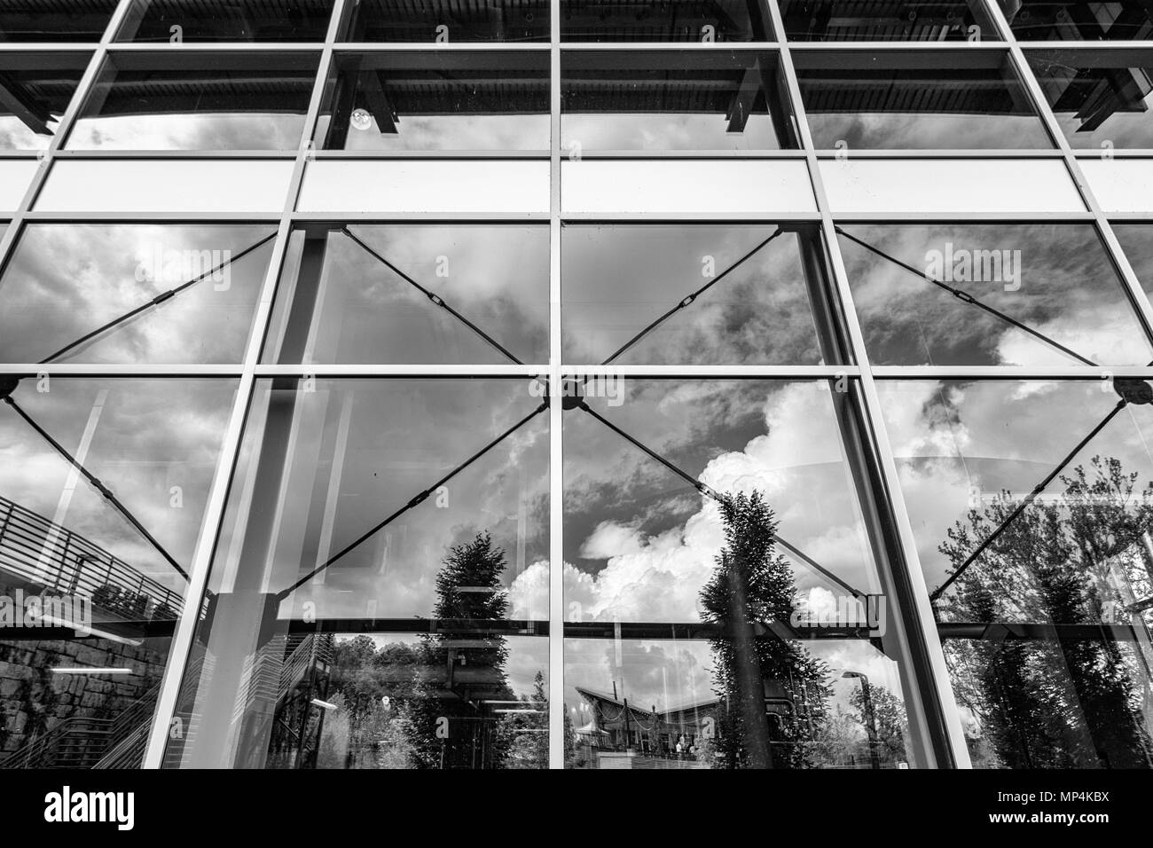 Reflection from the geometric windows reveal the tasting room and a dramatic sky at the New Belgium Brewing Company in Asheville, NC, USA Stock Photo