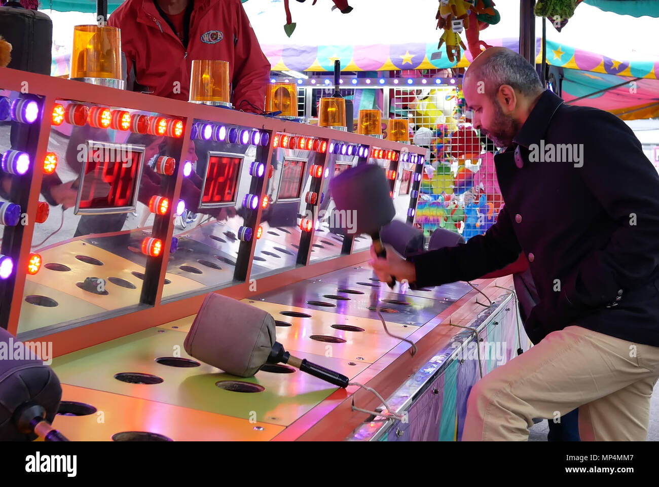 Coquitlam, BC, Canada - April 15, 2018 : Motion of people playing whack game at the West Coast Amusements Carnival Stock Photo
