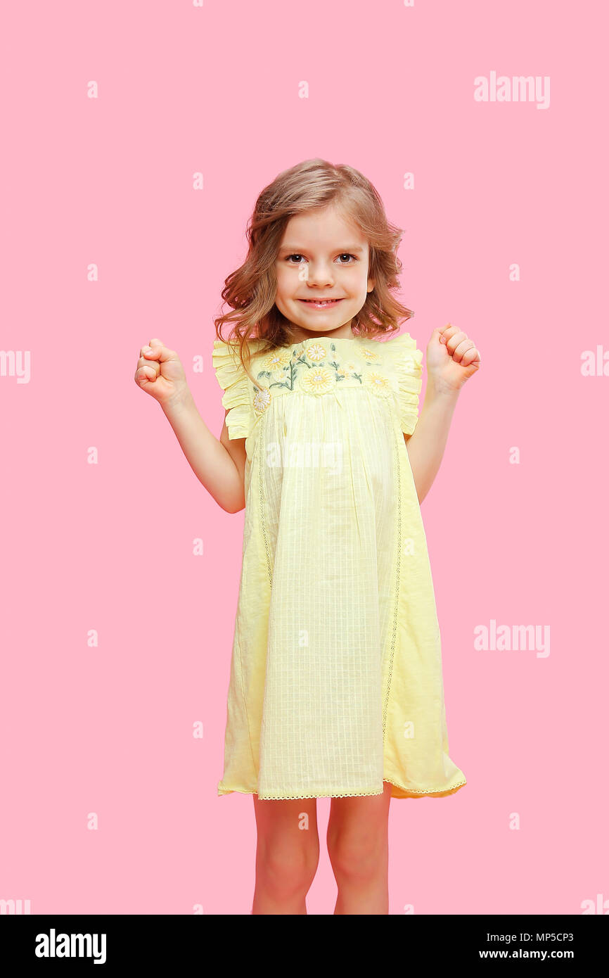 Charming girl in dress on pink Stock Photo - Alamy