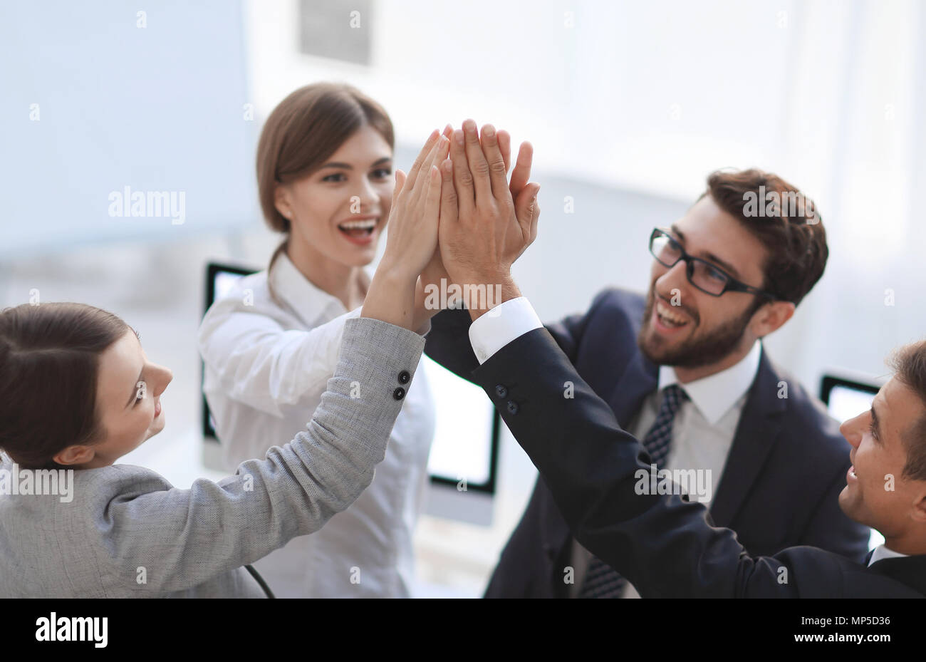 successful business team giving each other a high-five, standing in the ...