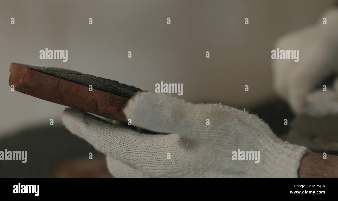closeup worker applying concrete glue to brick cuts tile Stock Photo Alamy