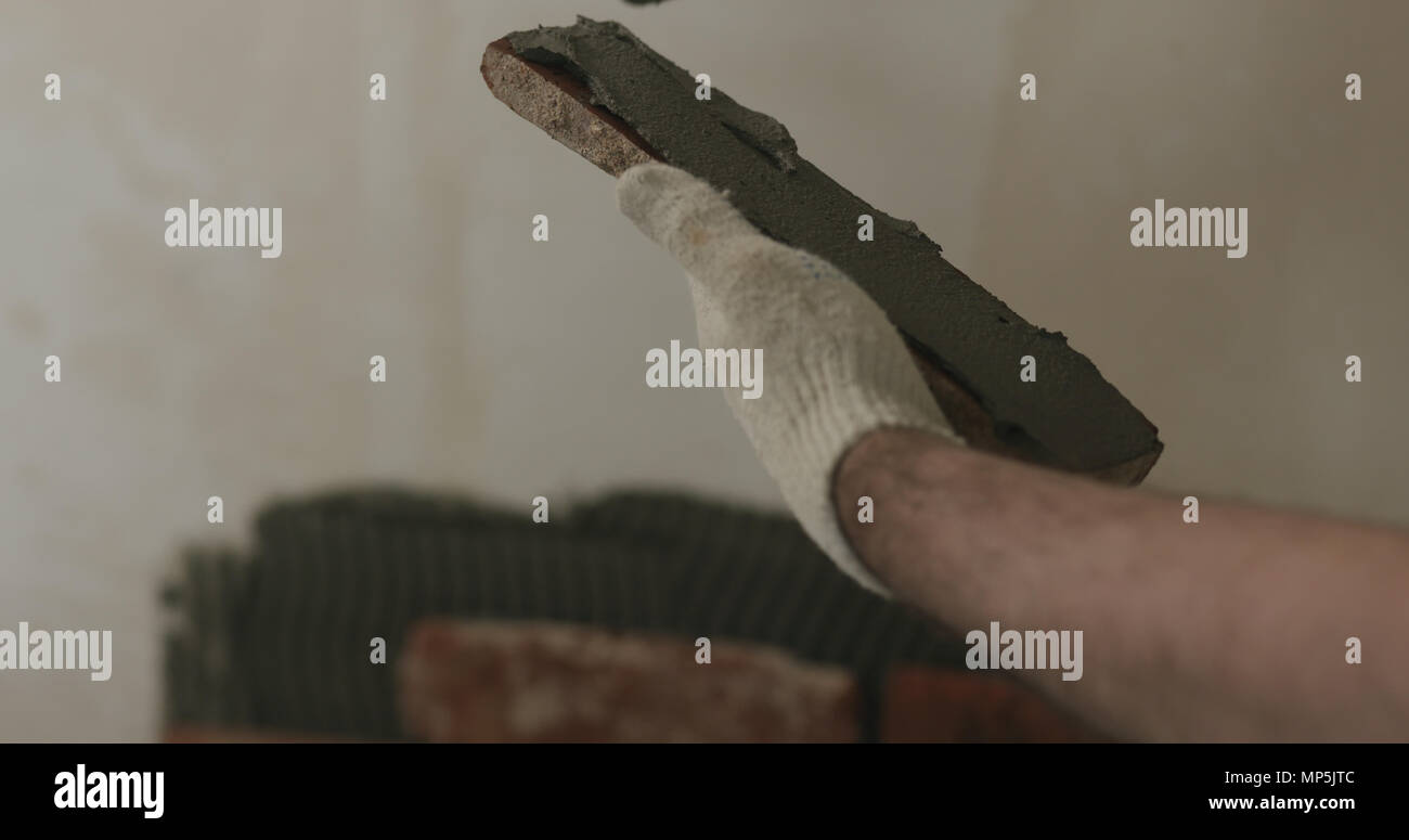 closeup worker applying concrete glue to brick cuts tile Stock Photo Alamy