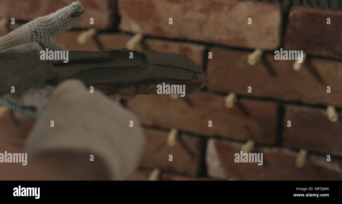 closeup worker applying concrete glue to brick cuts tile Stock Photo Alamy