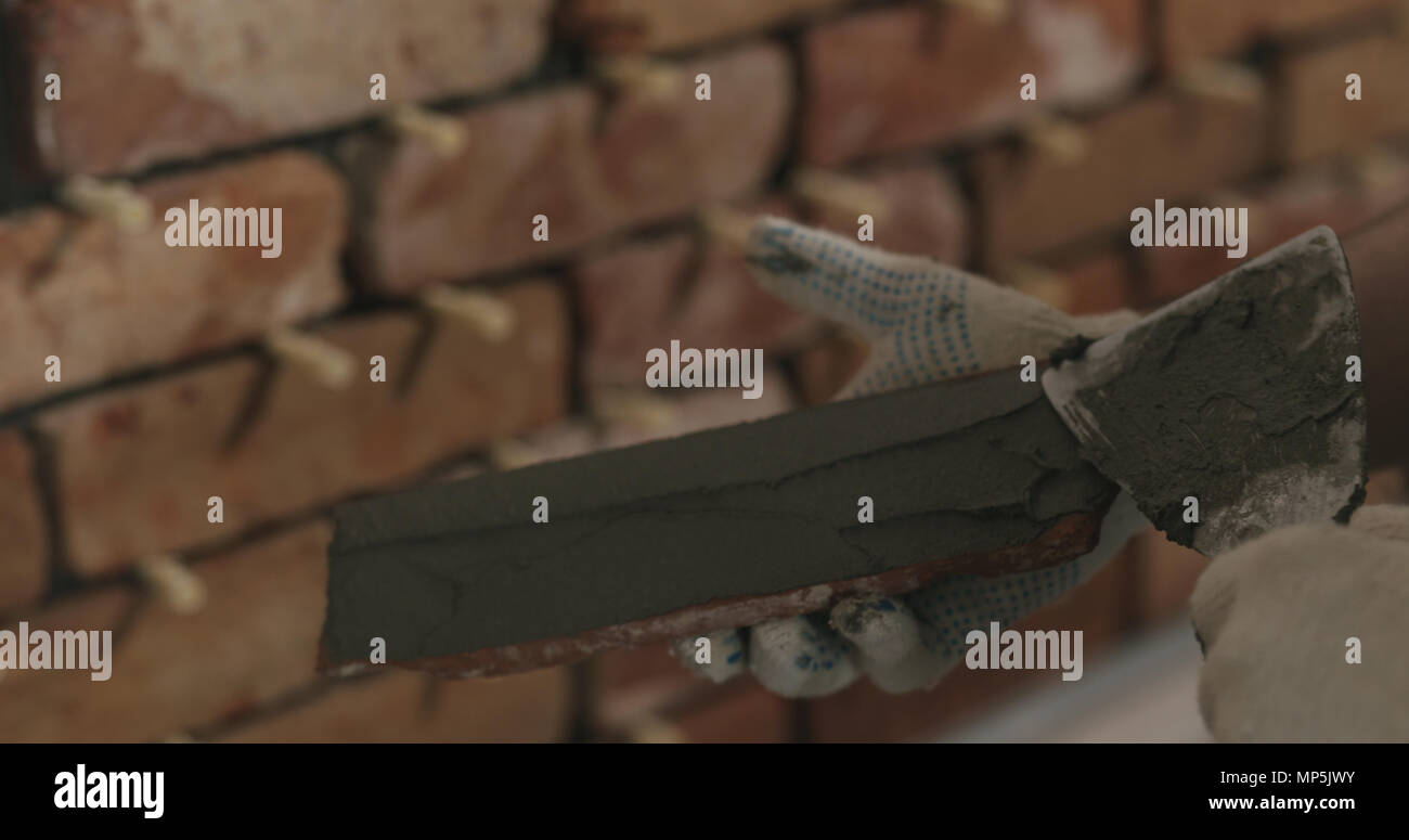 closeup worker applying concrete glue to brick cuts tile Stock Photo Alamy