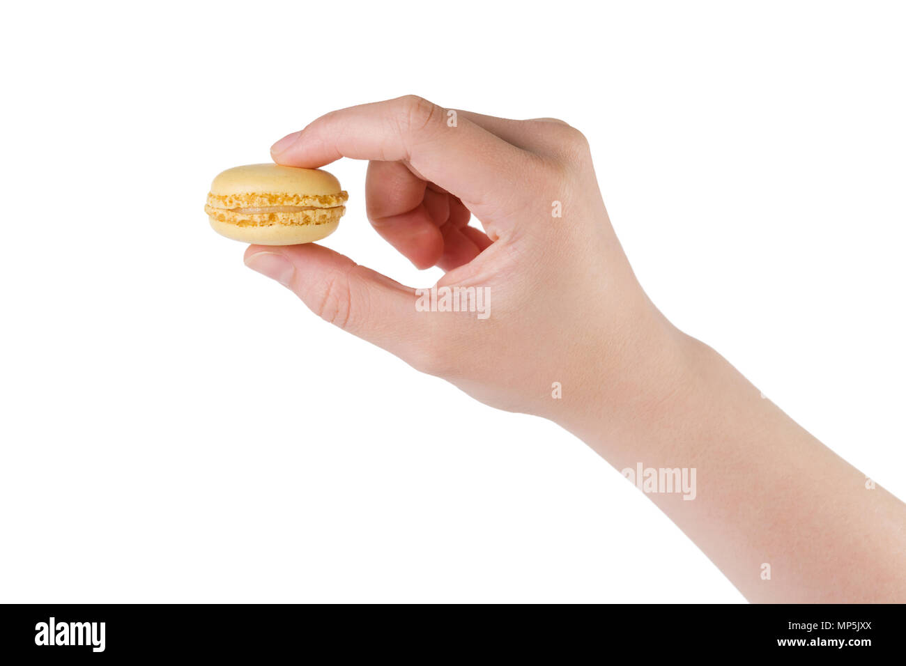 young female hand holding yellow macaron isolated on white Stock Photo