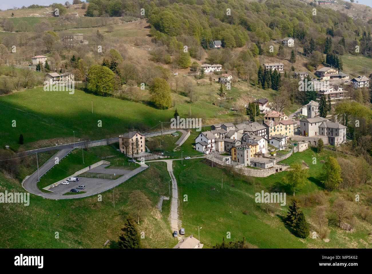 aerial shot, from a small plane, of Valcava mountain village, shot on a bright springtime day in Orobie, Bergamo,  Lombardy , Italy Stock Photo