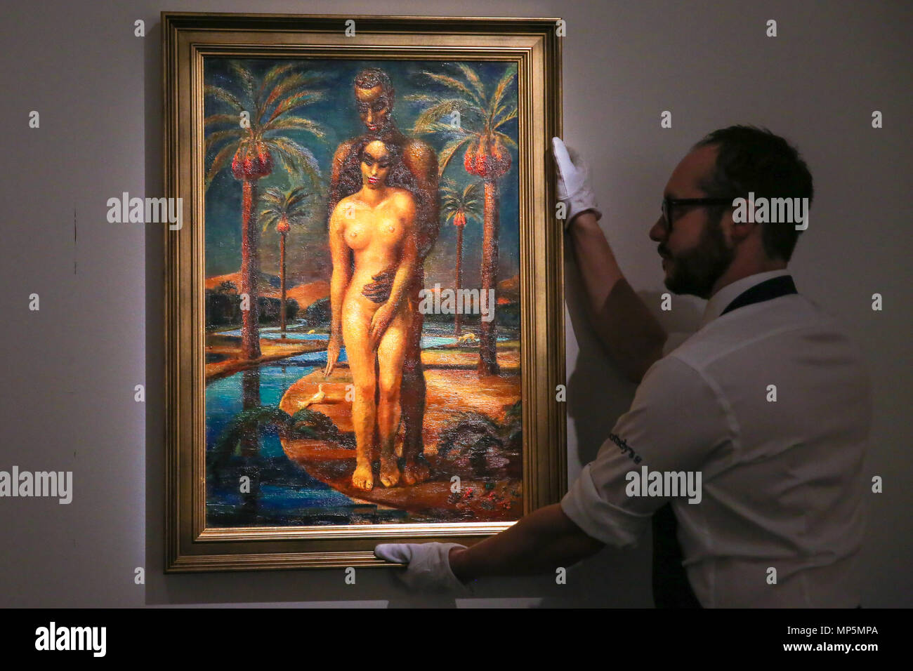 Covering over 1,500 years of exquisite bejewelled and historic objects, sumptuous rugs, luminous orientalist paintings and iconic modern and contemporary canvases on auction at Sotheby’s  Featuring: A technician hangs Mahmoud Said, Adam and Eve, oil on panel, 1937 (est. £300, 000-500, 000) Where: London, United Kingdom When: 20 Apr 2018 Credit: Dinendra Haria/WENN Stock Photo