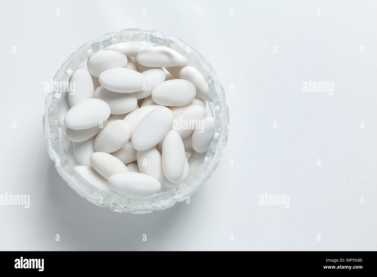 confetti in a glass bowl with white background Stock Photo