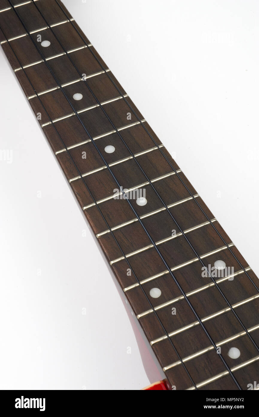 the keyboard of a ukulele in white background Stock Photo - Alamy