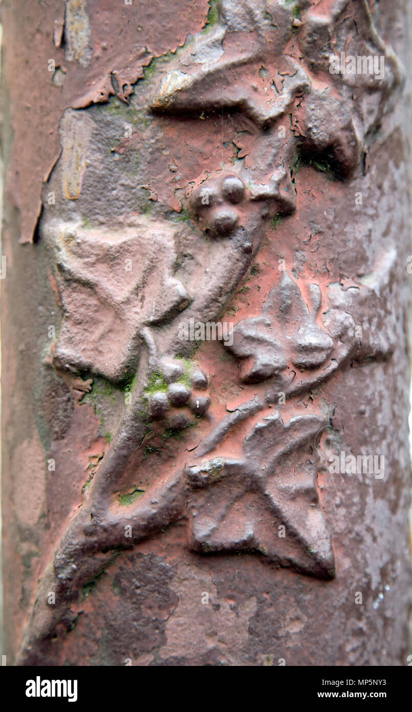 Portrait shot of relief art nouveau detail in relief on a cast iron lamp post. Stock Photo