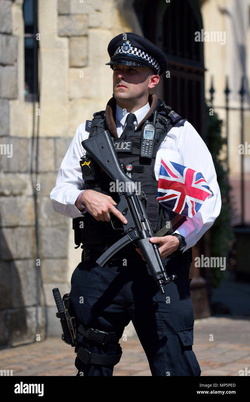 Royal Wedding. Police with flag. Armed policeman with British Union Jack flag tucked in his belt looking tough. Windsor Castle. Gun. Weapon Stock Photo