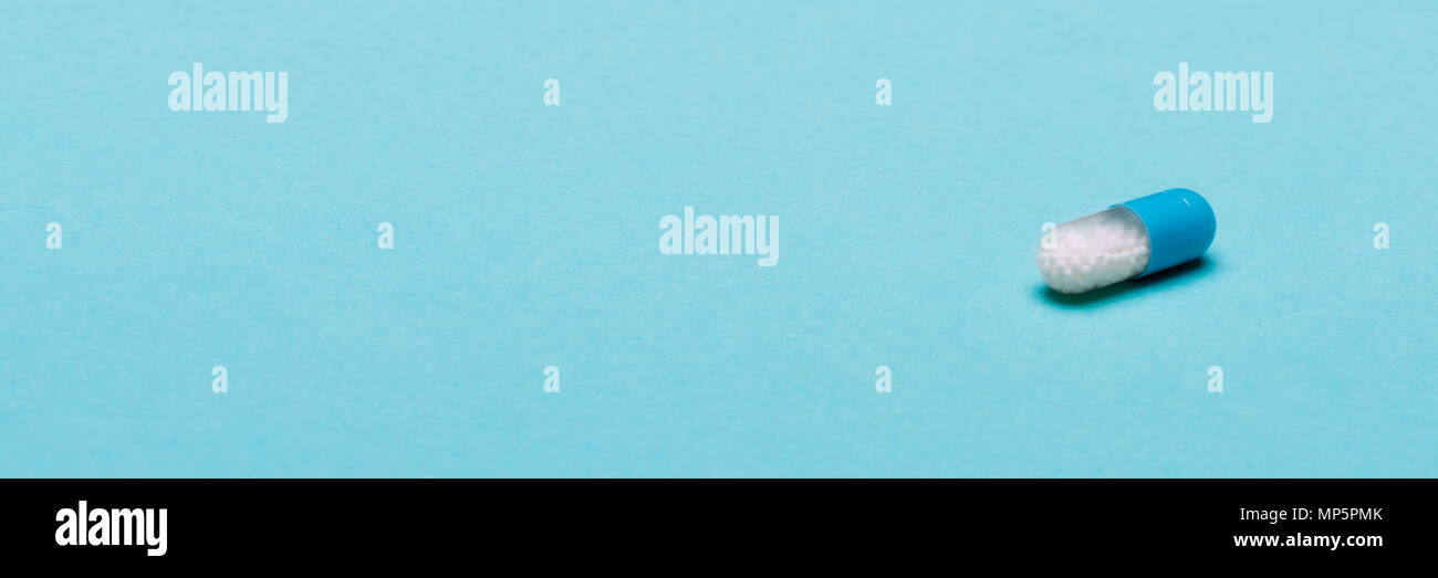 Single Medication Single medication capsule on blue pastel coloured background ...