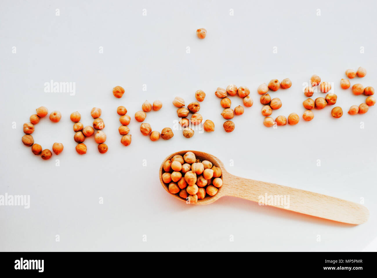 word chickpeas made of uncooked chickpeas on white background Stock