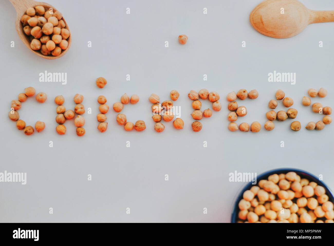 word chickpeas made of uncooked chickpeas on white background Stock