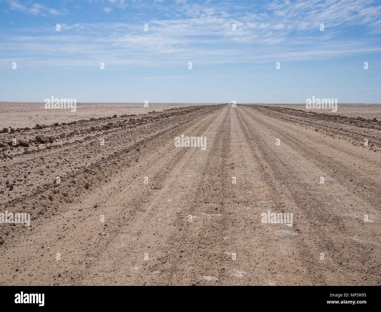 Endless empty dirt road in Namib desert of Namib-Naukluft National Park, Namibia, Africa Stock Photo