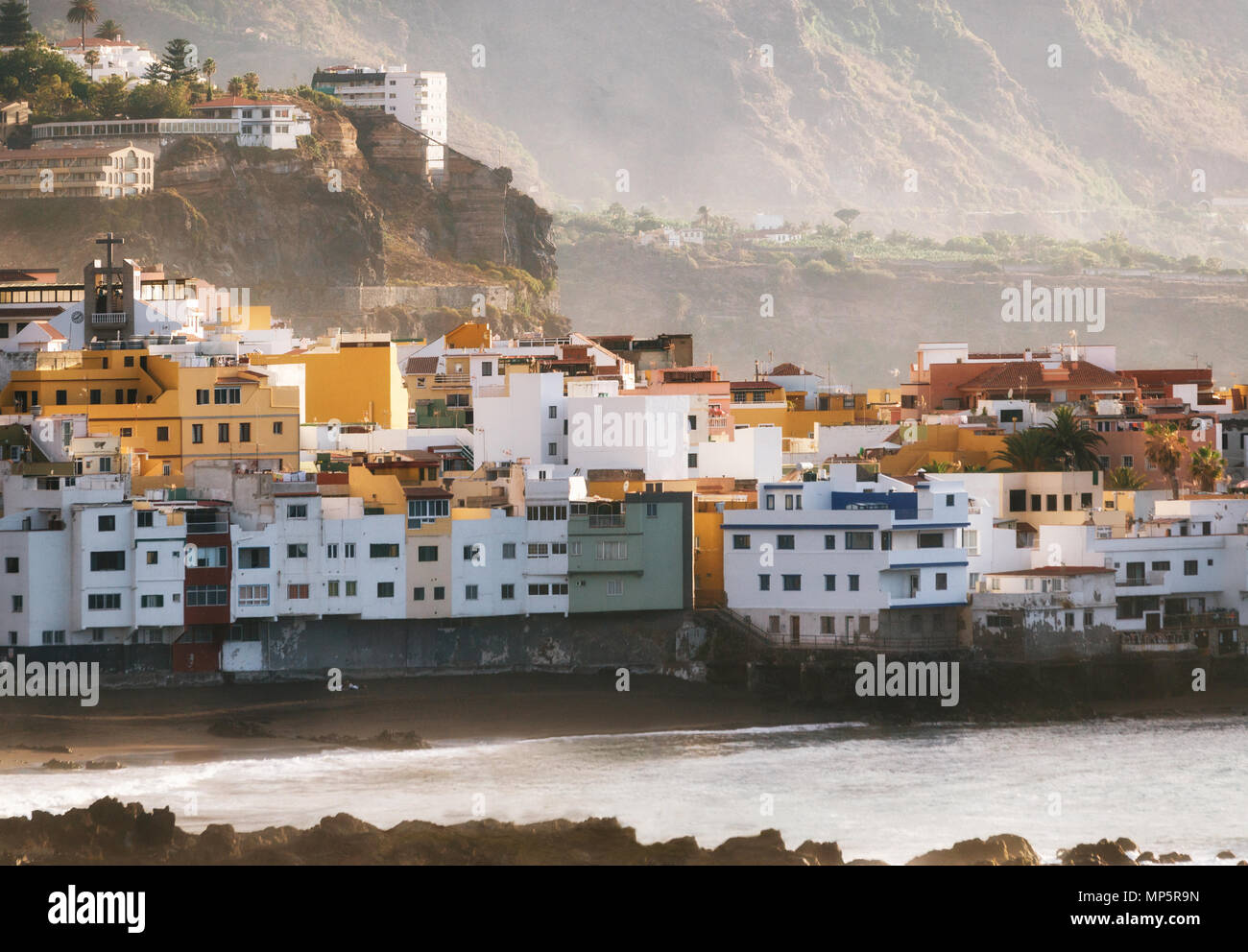View of colorful houses of Puerto de la cruz, Jardin beach with sunlight at sunset, Tenerife, Canary islands, Spain Stock Photo