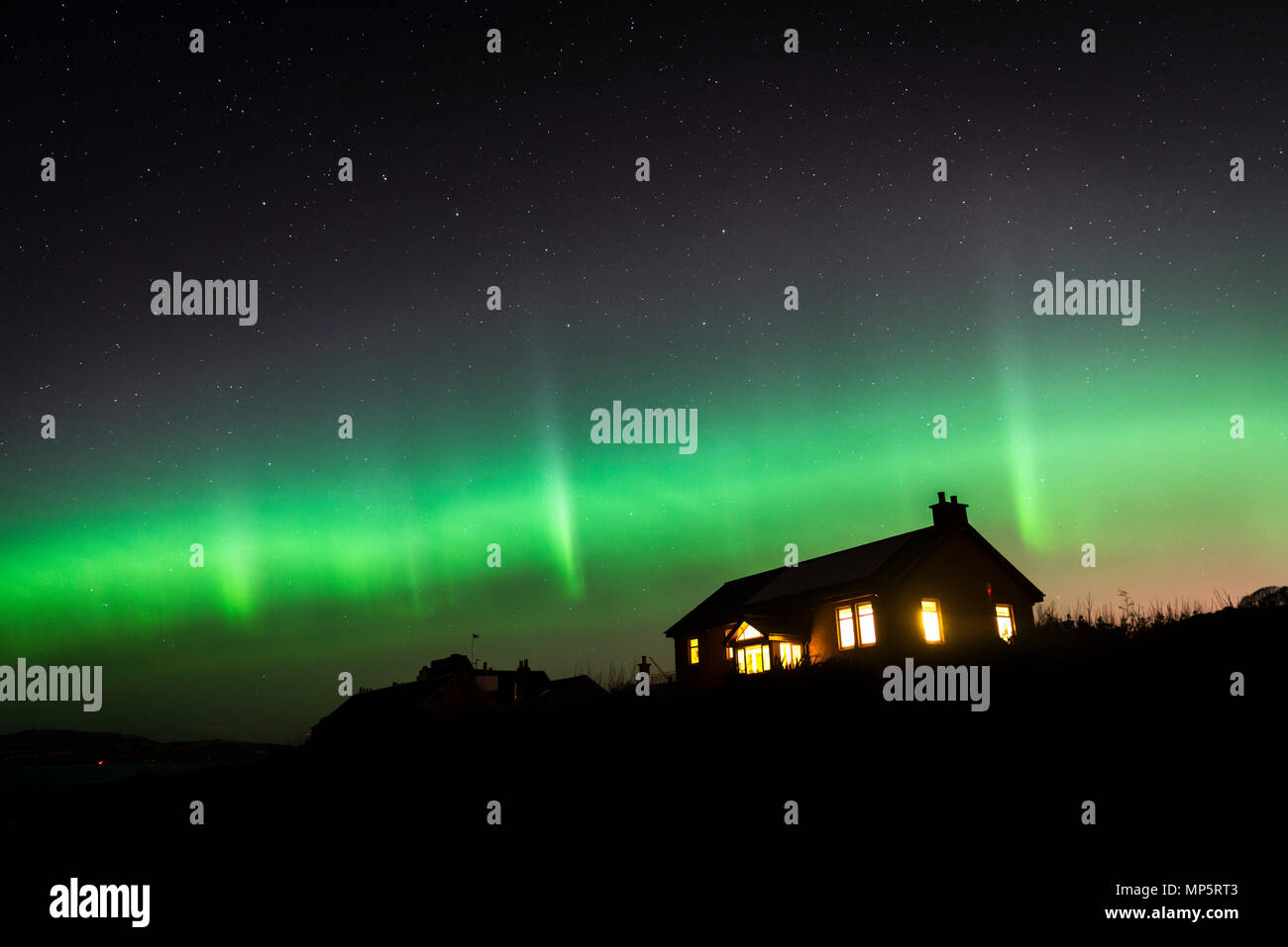 The Aurora Borealis or Northern Lights at Portencross, Ayrshire, Scotland, UK Stock Photo