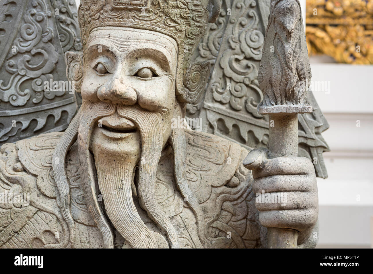 The face of a stone carving in the grounds of the Wat Pho (the Temple of the Reclining Buddha), or Wat Phra Chetuphon Bangkok Thailand Stock Photo