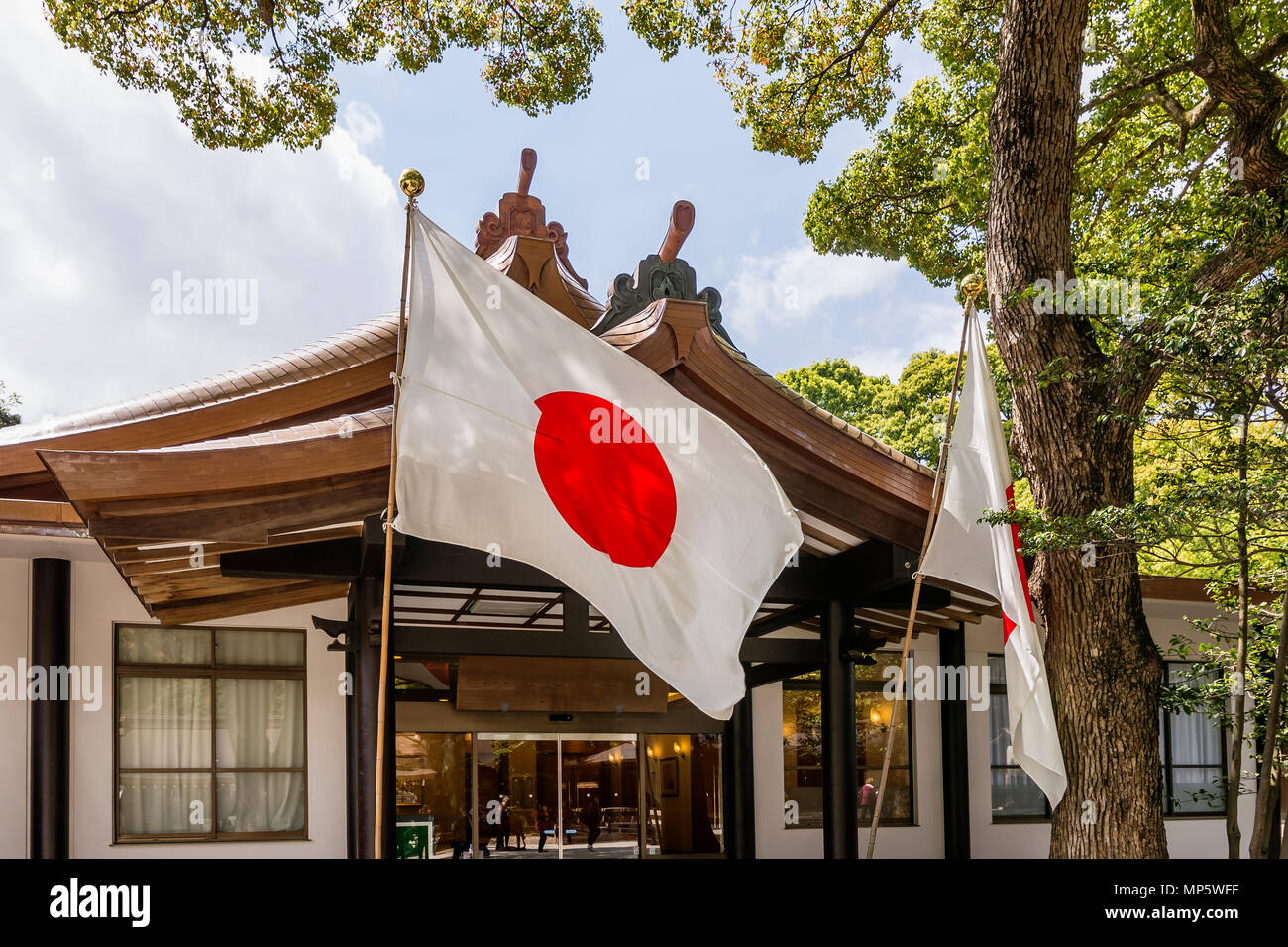 Flag of Japan waving in the Meiji shrine in Tokyo Stock Photo