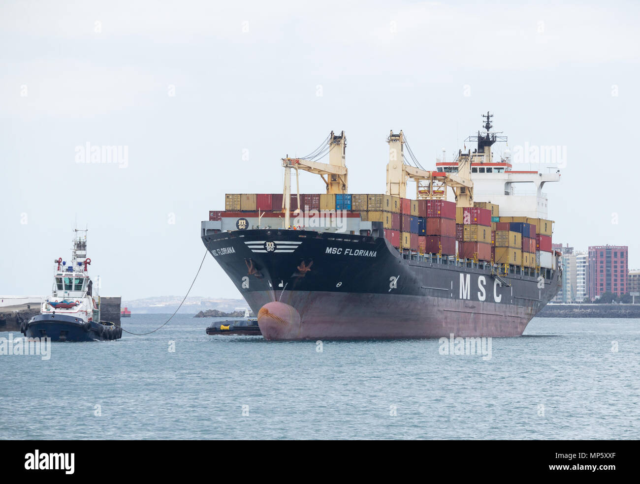 Tug boats guiding MSC Floriana container ship into port in Las Palmas on Gran Canaria, Canary Islands, Spain Stock Photo