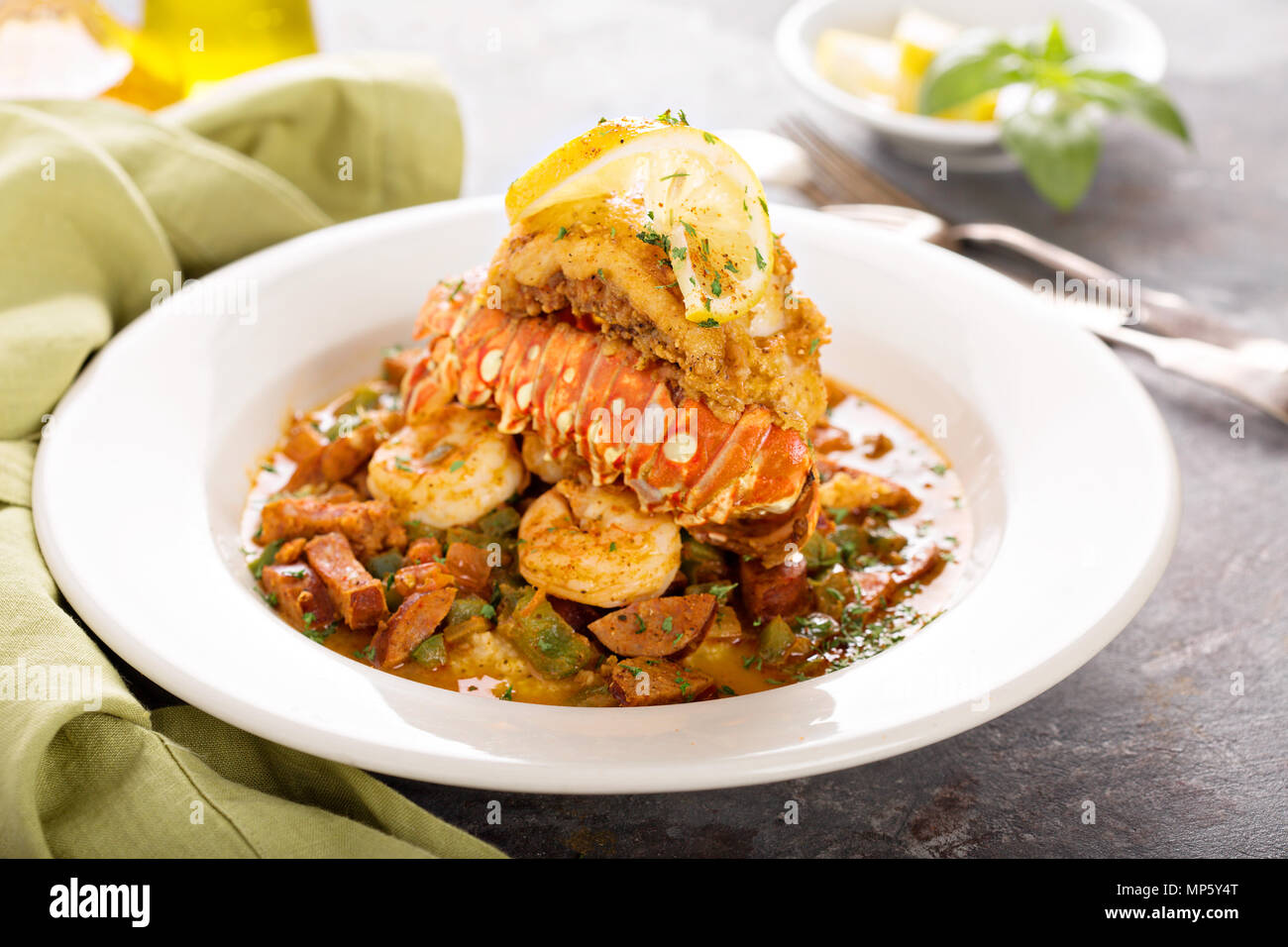 Grits with a lobster tail, shrimp and sausage Stock Photo