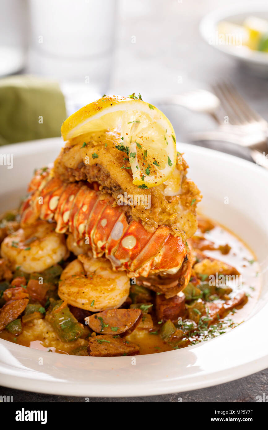 Grits with a lobster tail, shrimp and sausage Stock Photo