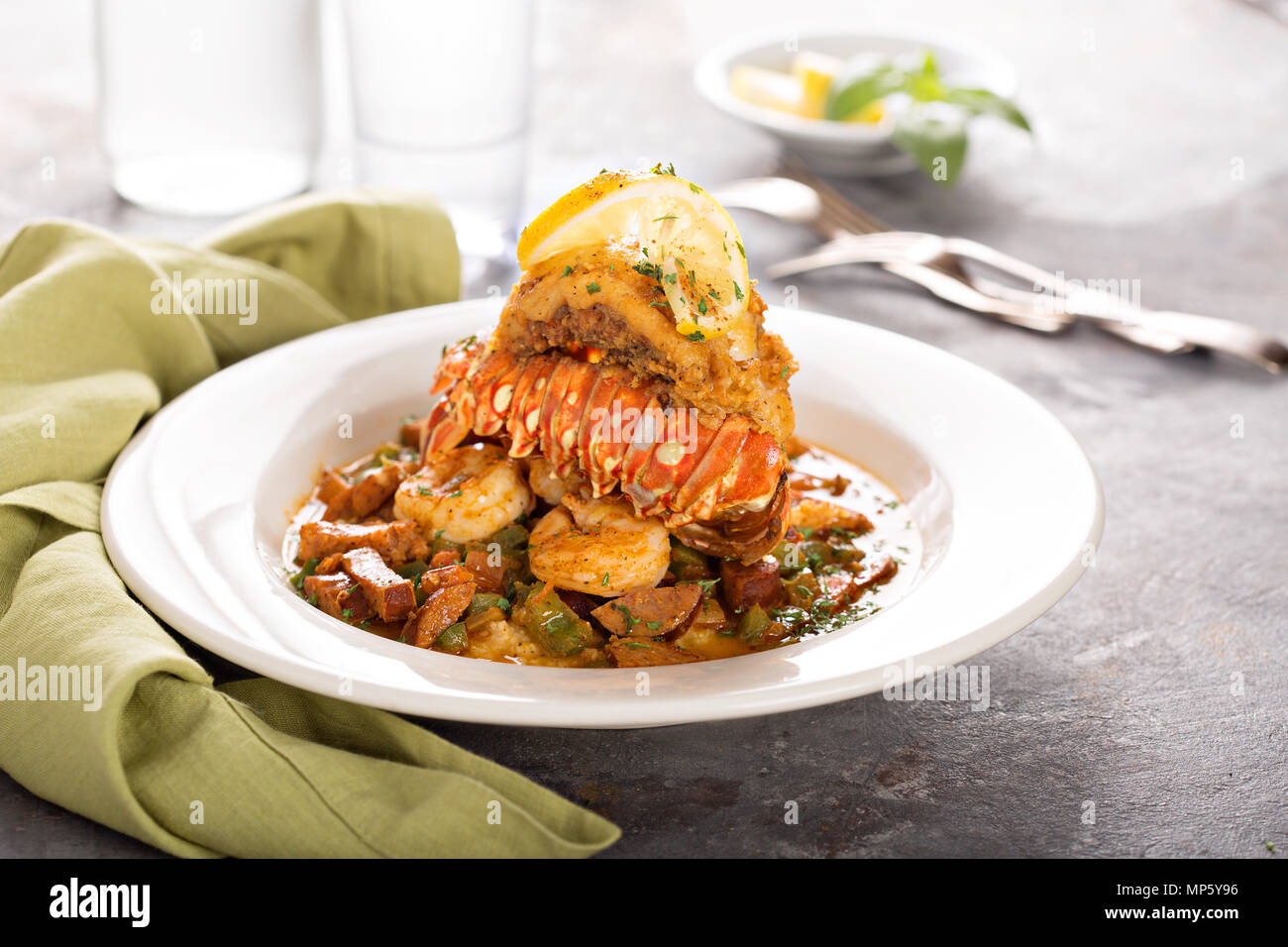Grits with a lobster tail, shrimp and sausage Stock Photo