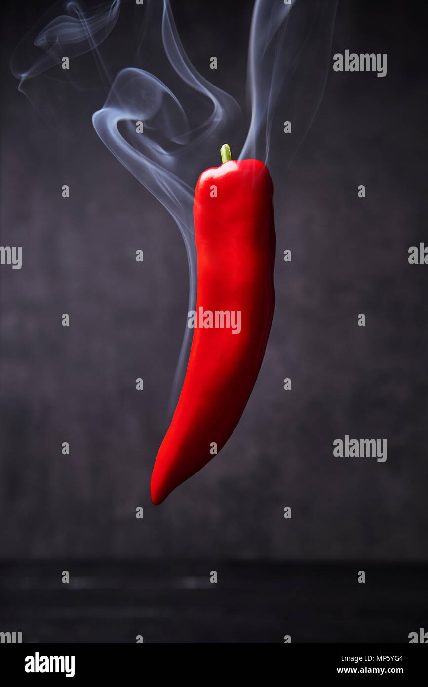 Smoking red hot pepper. Smoked paprika on black background with copy space  Stock Photo - Alamy