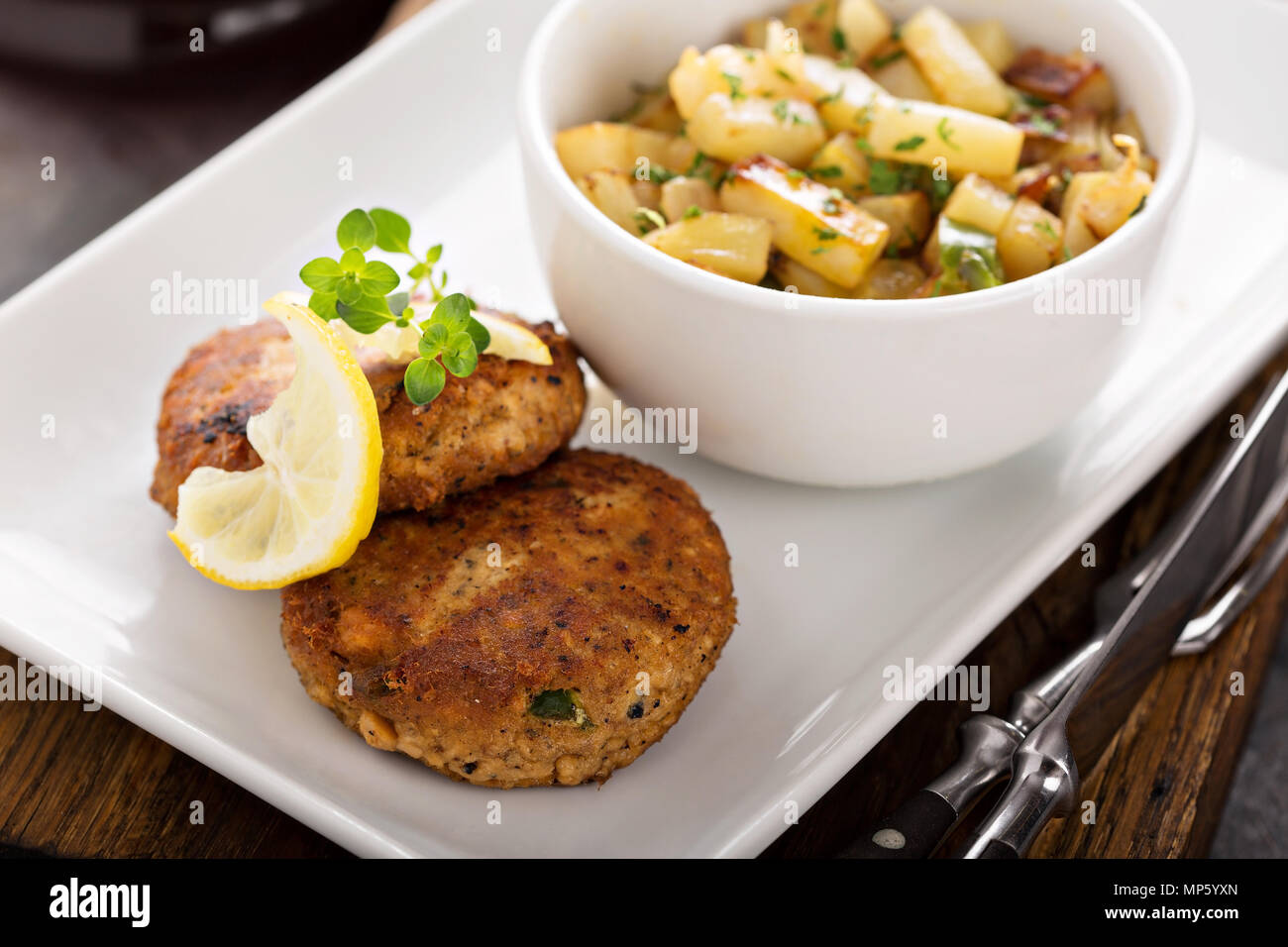 Crab cakes with potatoes Stock Photo Alamy