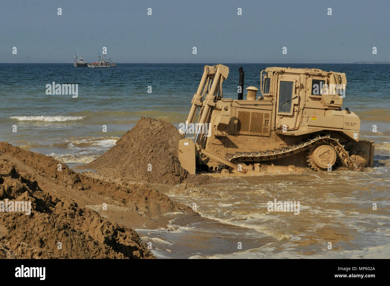 A bulldozer opens up the “duck pond” as the first section of the 331st Transportation Company’s Trident Pier gradually moves into position along Dogu Beach near the South Korean port city of Pohang, April 7, 2017, in preparation of Operation Pacific Reach Exercise 2017. The pier is just one of the many elements of the combined Republic of Korea – U.S. training exercise that can be employed worldwide during humanitarian assistance and disaster Relief operations, contingencies or crisis response. Also known as OPRex17, the exercise is a bilateral training event designed to ensure readiness and s Stock Photo