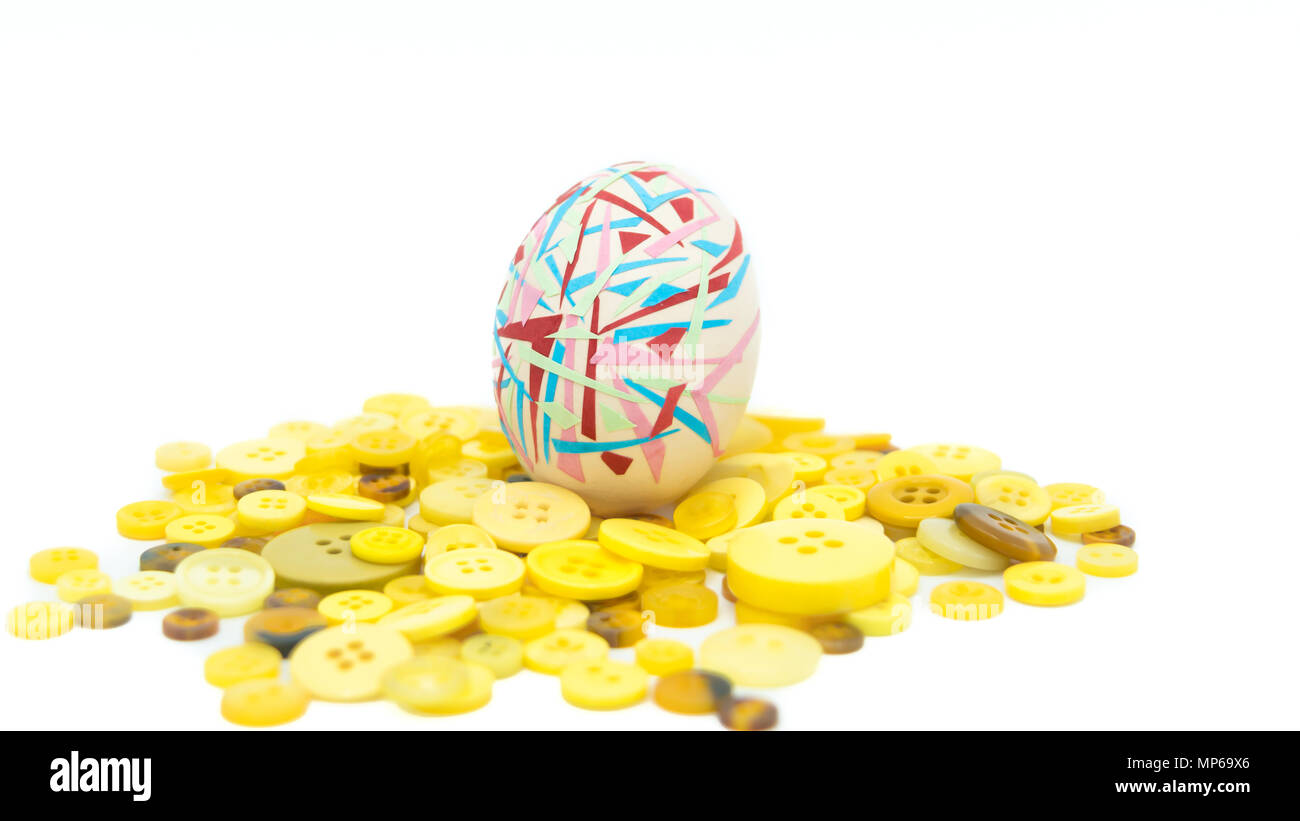 isolated happy easter, colorful easter egg standing on the yellow button, easter holiday decorations, easter concept backgrounds Stock Photo