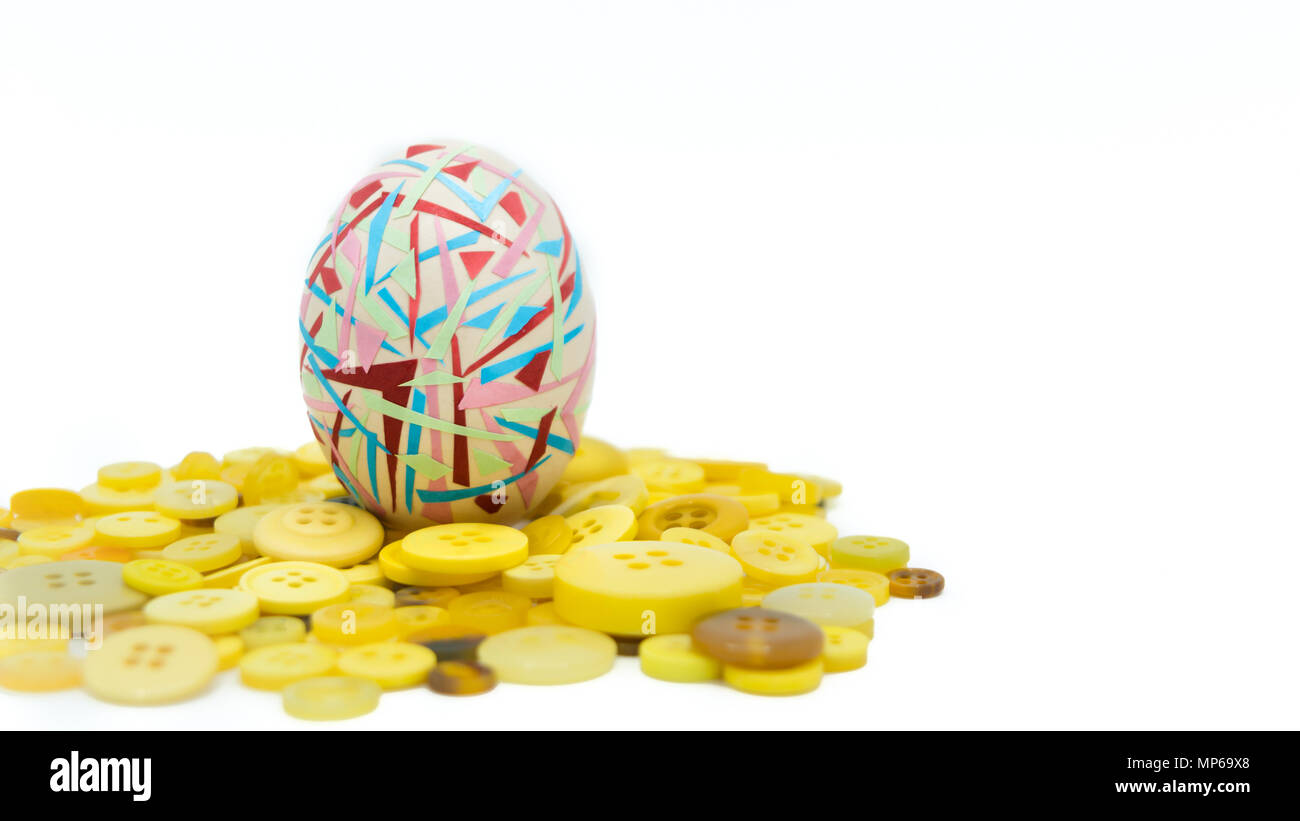 isolated happy easter, colorful easter egg standing on the yellow button, easter holiday decorations, easter concept backgrounds Stock Photo