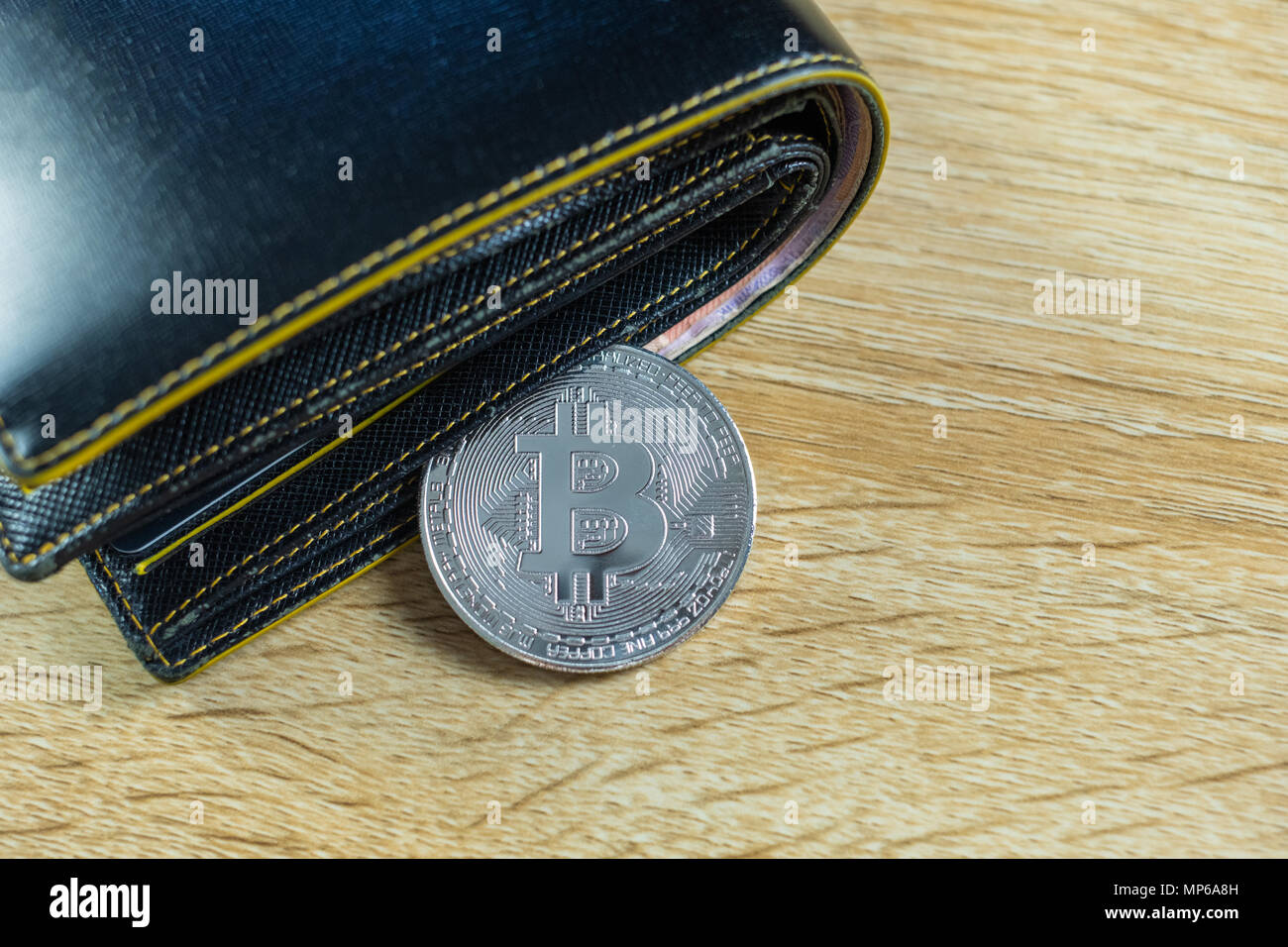Bitcoin digital currency instead real money, bit-coin with leather wallet  or purse on wooden working table, virtual cryptocurrency money business  conc Stock Photo - Alamy