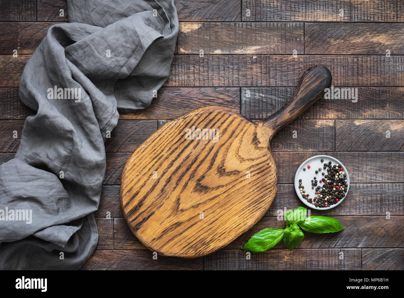 Wooden cutting board, kitchen textile and spices. Food background in rustic style with copy space for text. Great suit for menu, restaurants, blogs an Stock Photo