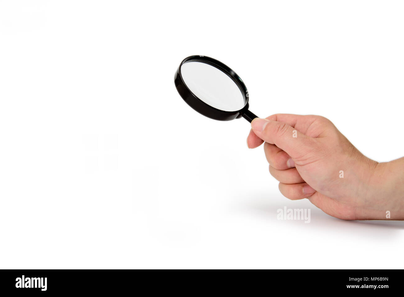 Hand holding magnifying glass isolated on white background Stock Photo