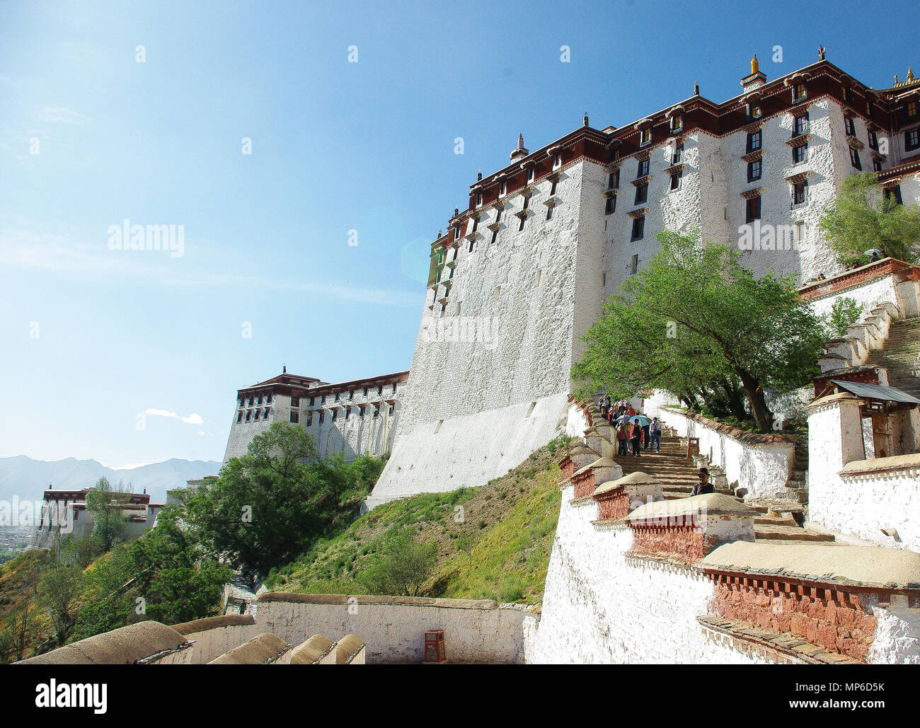 Potala Palace in Lhasa Tibet China view in the morning sun. clouds and sun. Summer day. Side view from below Stock Photo