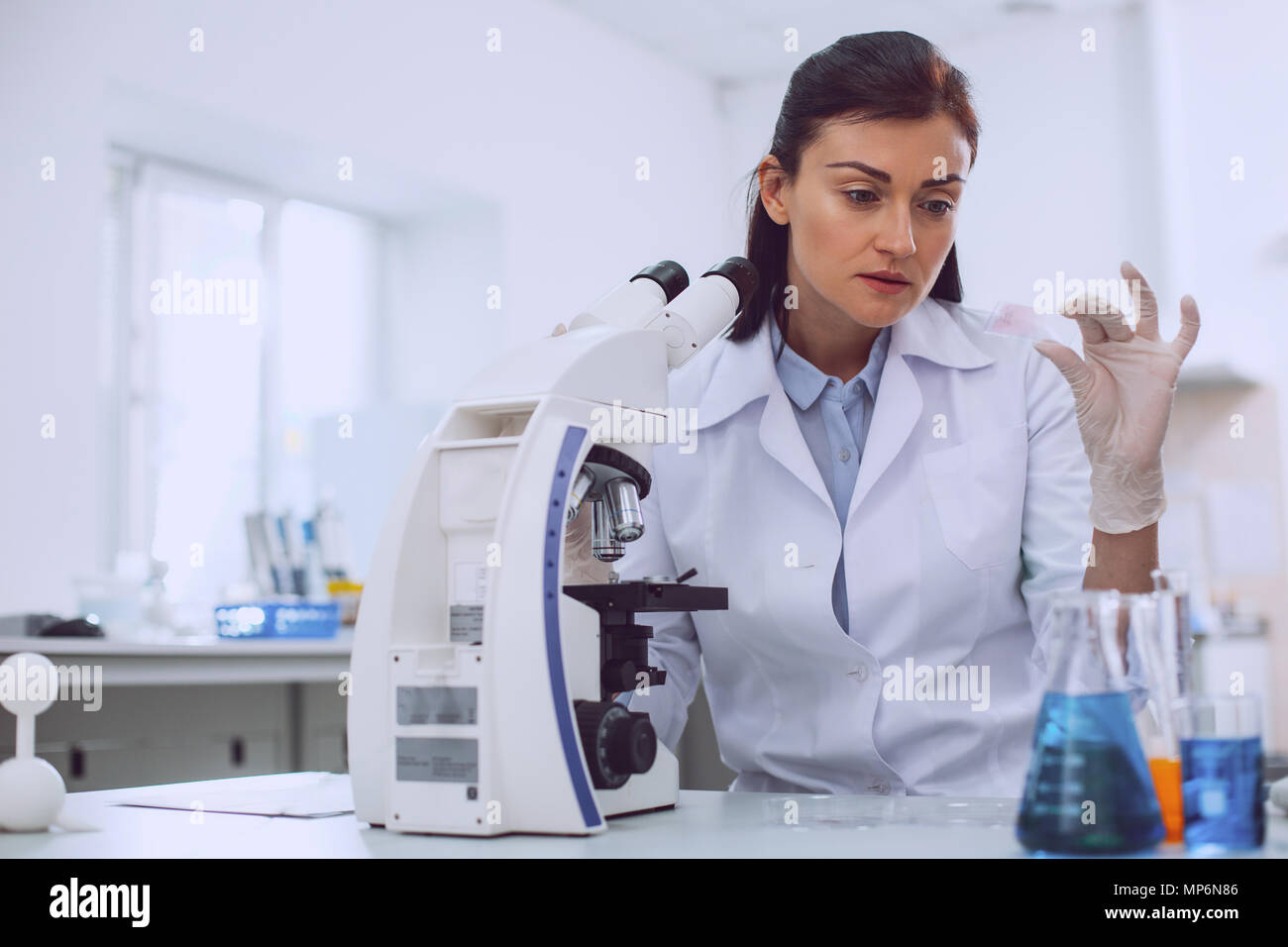 Determined biologist holding a sample Stock Photo
