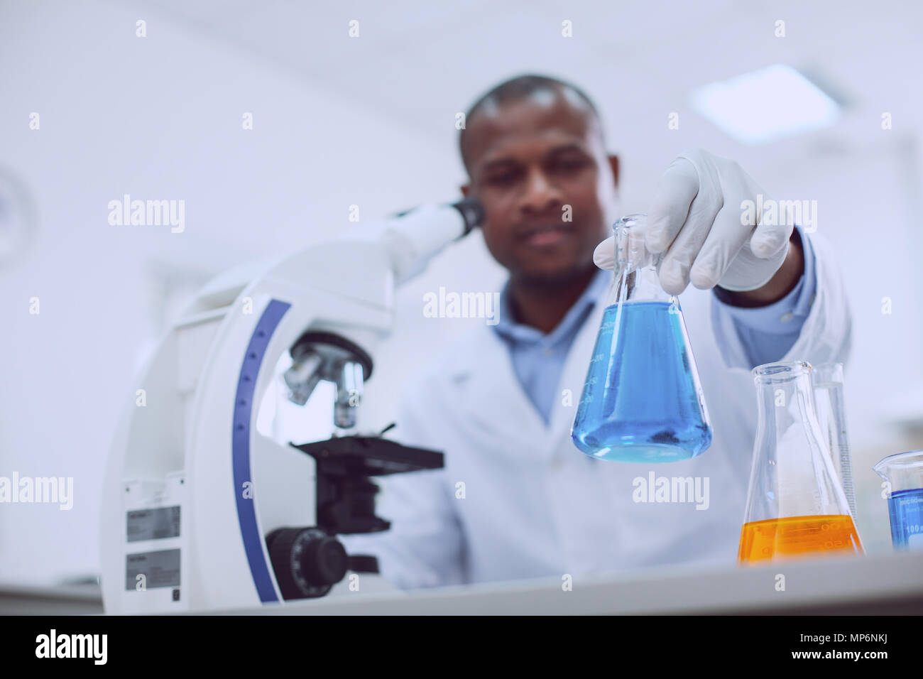 Professional biologist working with his microscope Stock Photo