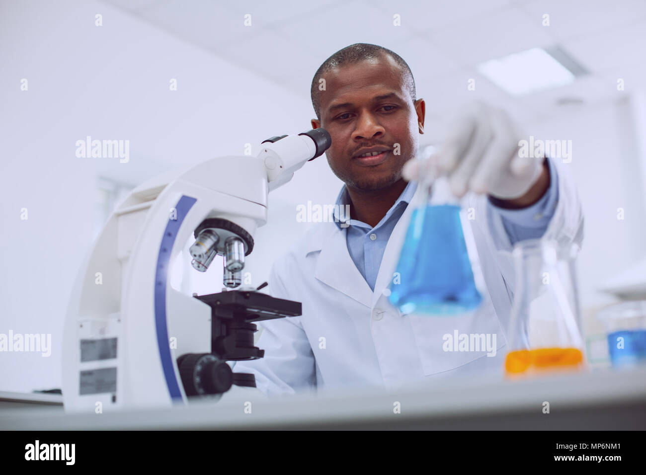 Successful biologist working with his microscope Stock Photo