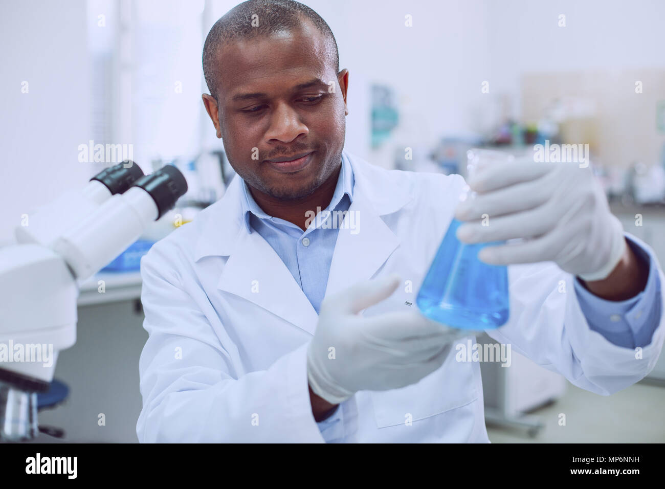 Unsmiling biologist holding his tube Stock Photo Alamy