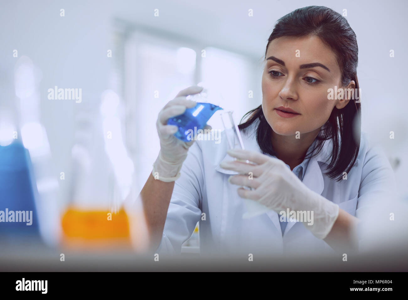 Joyful female scientist doing a new test Stock Photo