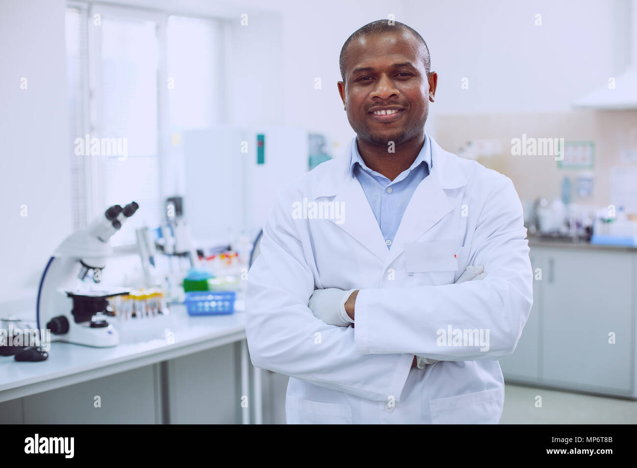 Smiling biologist standing in the lab Stock Photo