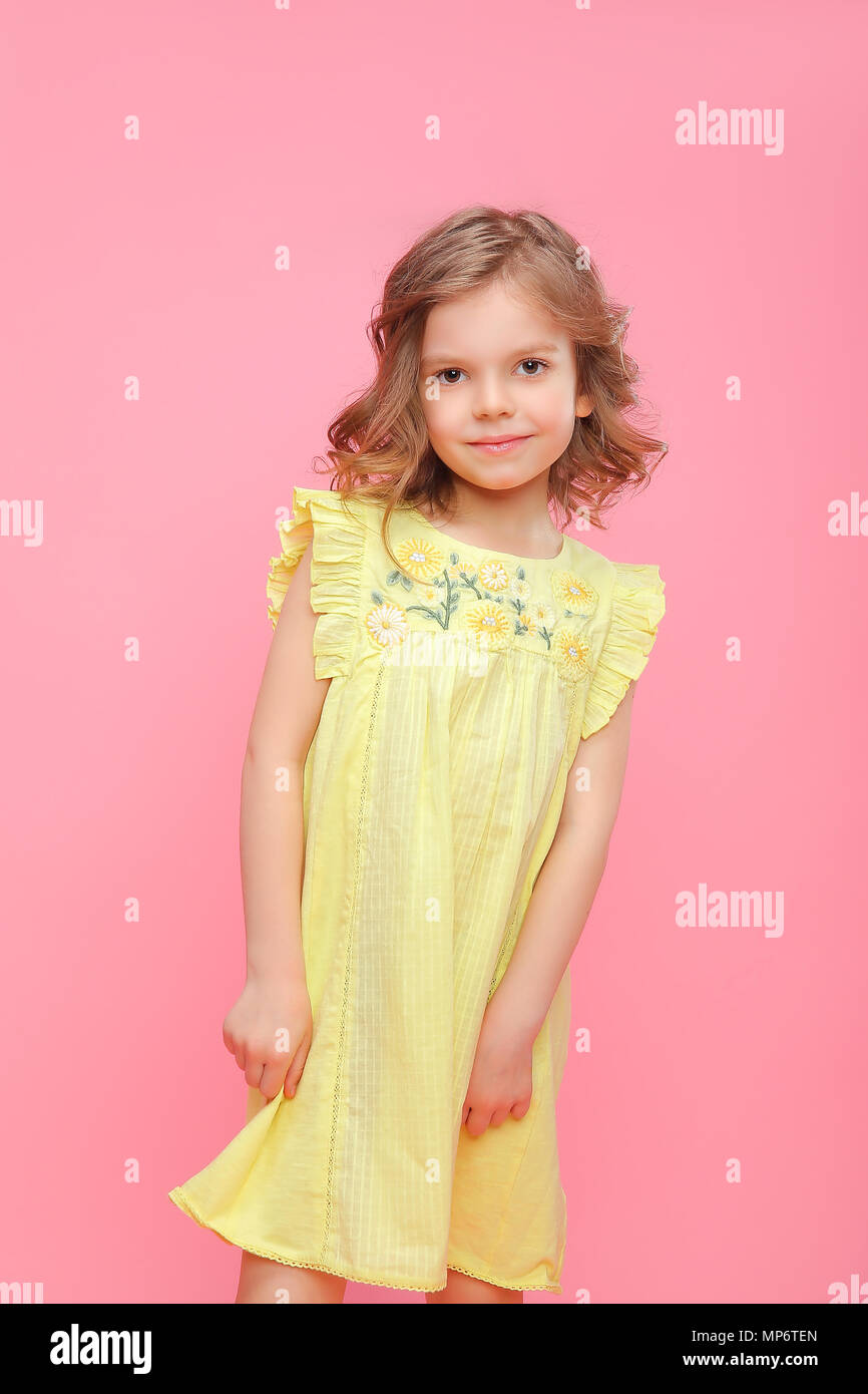 Charming girl in dress on pink Stock Photo - Alamy