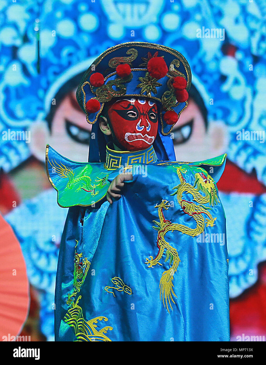 Wuhan, China's Hubei Province. 21st May, 2018. A student performs face-changing of Sichuan opera at a cultural and sports center in Wuhan, capital of central China's Hubei Province, May 21, 2018. Around 50 traditional Chinese operas were put onto stage here, with young performers from kindergartens to middles schools. Credit: Zhao Jun/Xinhua/Alamy Live News Stock Photo