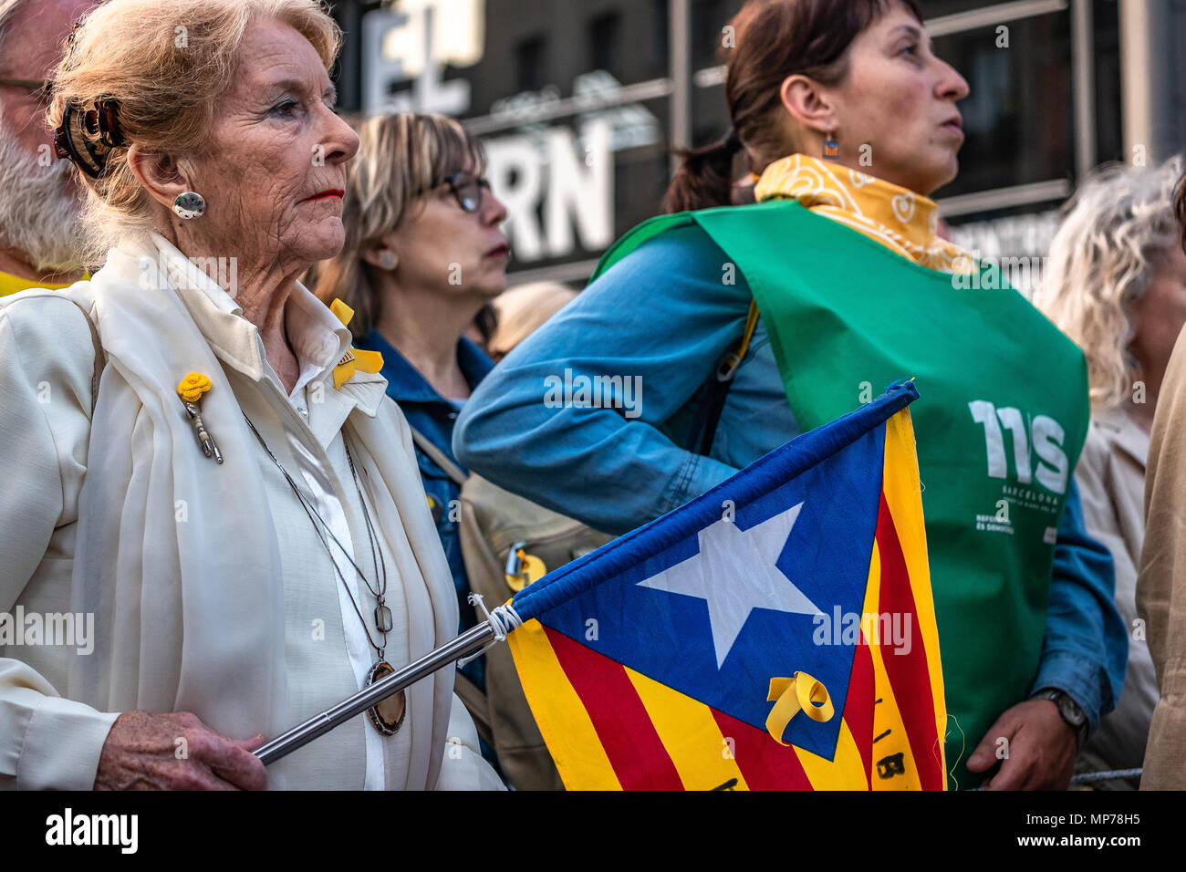 A woman is seen with a flag for the independence of Catalonia. Hundreds of people have concentrated protesting the maintenance of Article 155 that prevents the normal functioning of the Catalan government and institutions after the appointment of President Quim Torra. Stock Photo