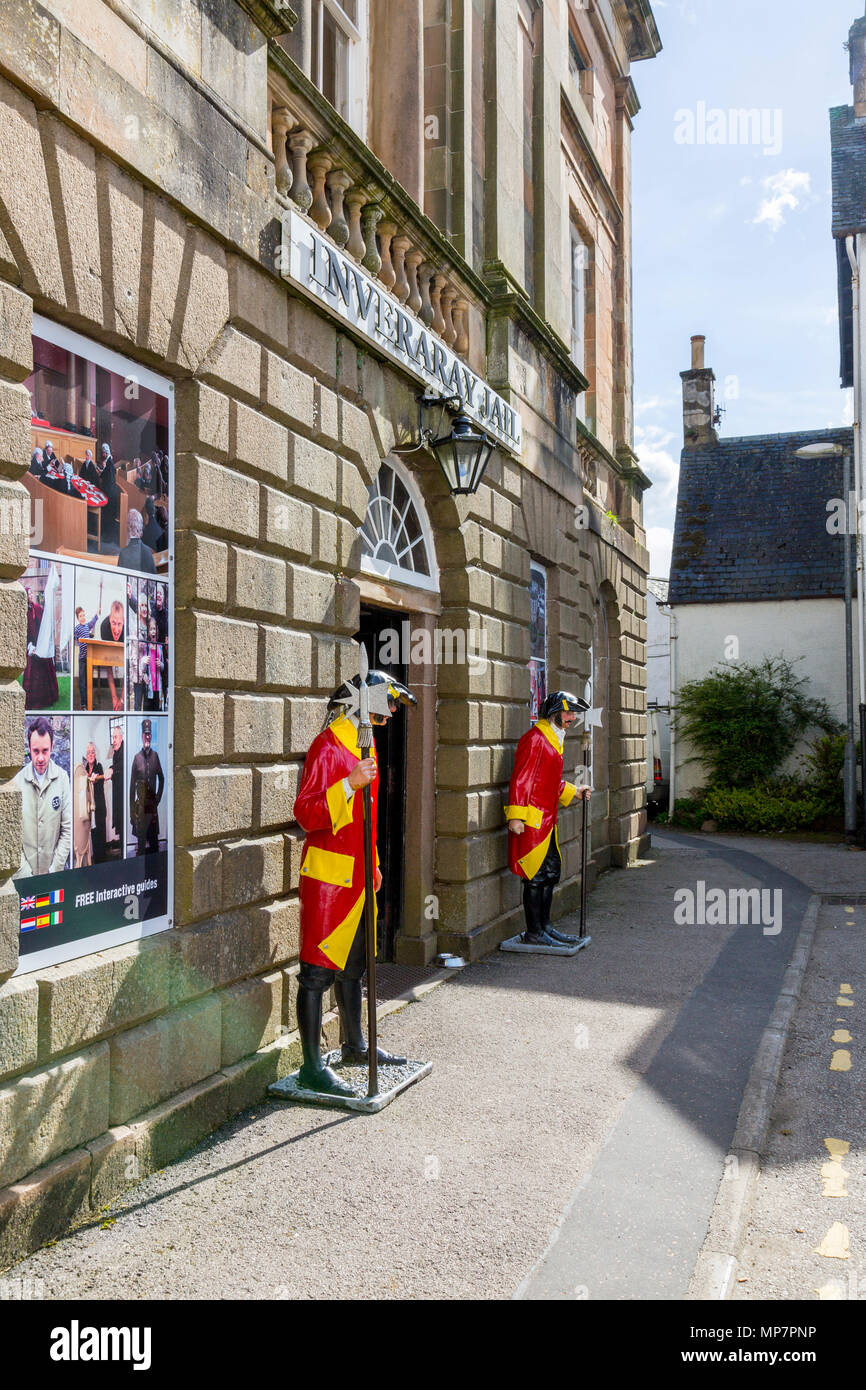 Two brightly coloured guards stand outside the historic Georgian 1820 Grade ‘A’ listed building of Inveraray Jail, Argyll & Bute, Scotland, UK Stock Photo