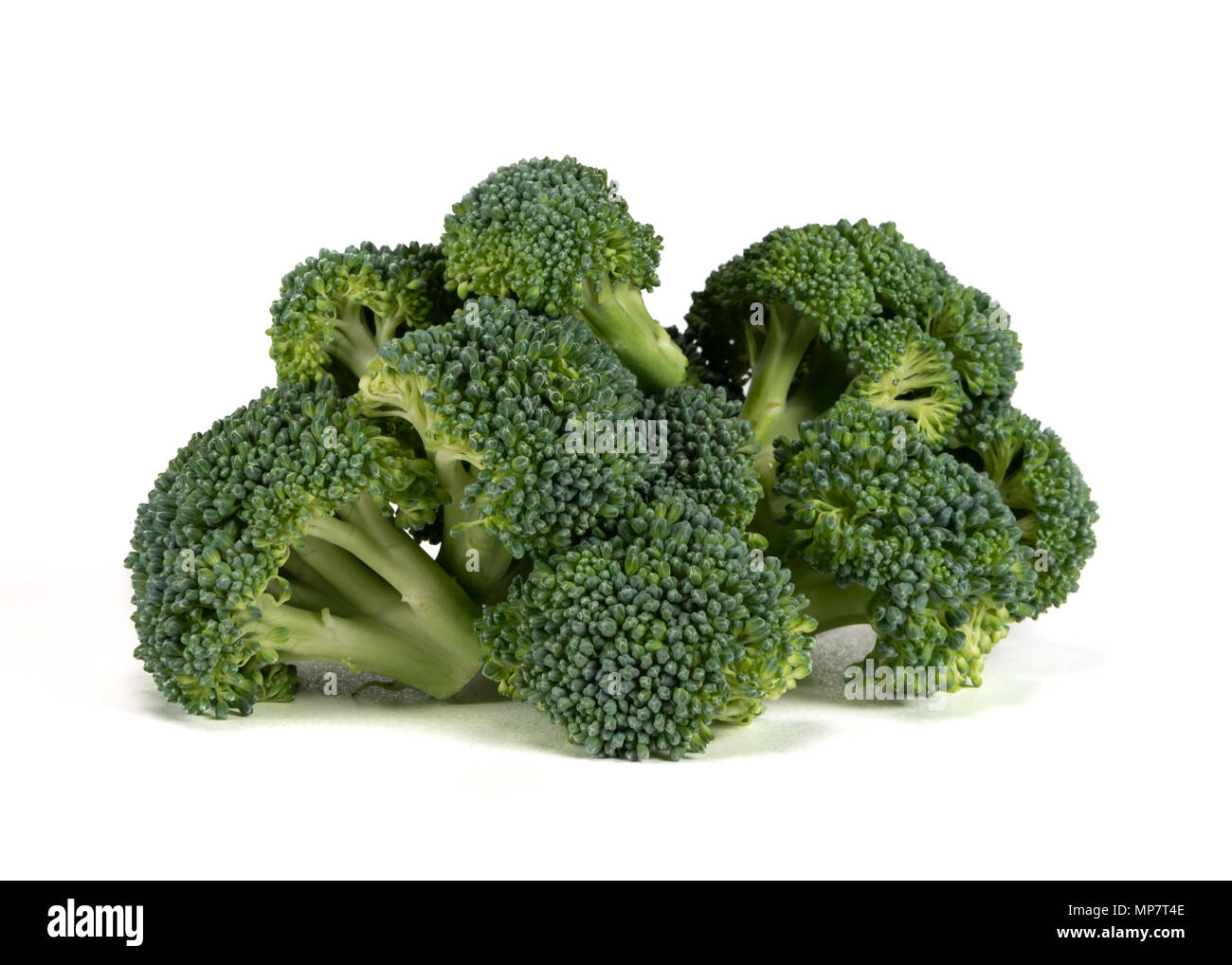 Large Pile of Broccoli on White Background Stock Photo
