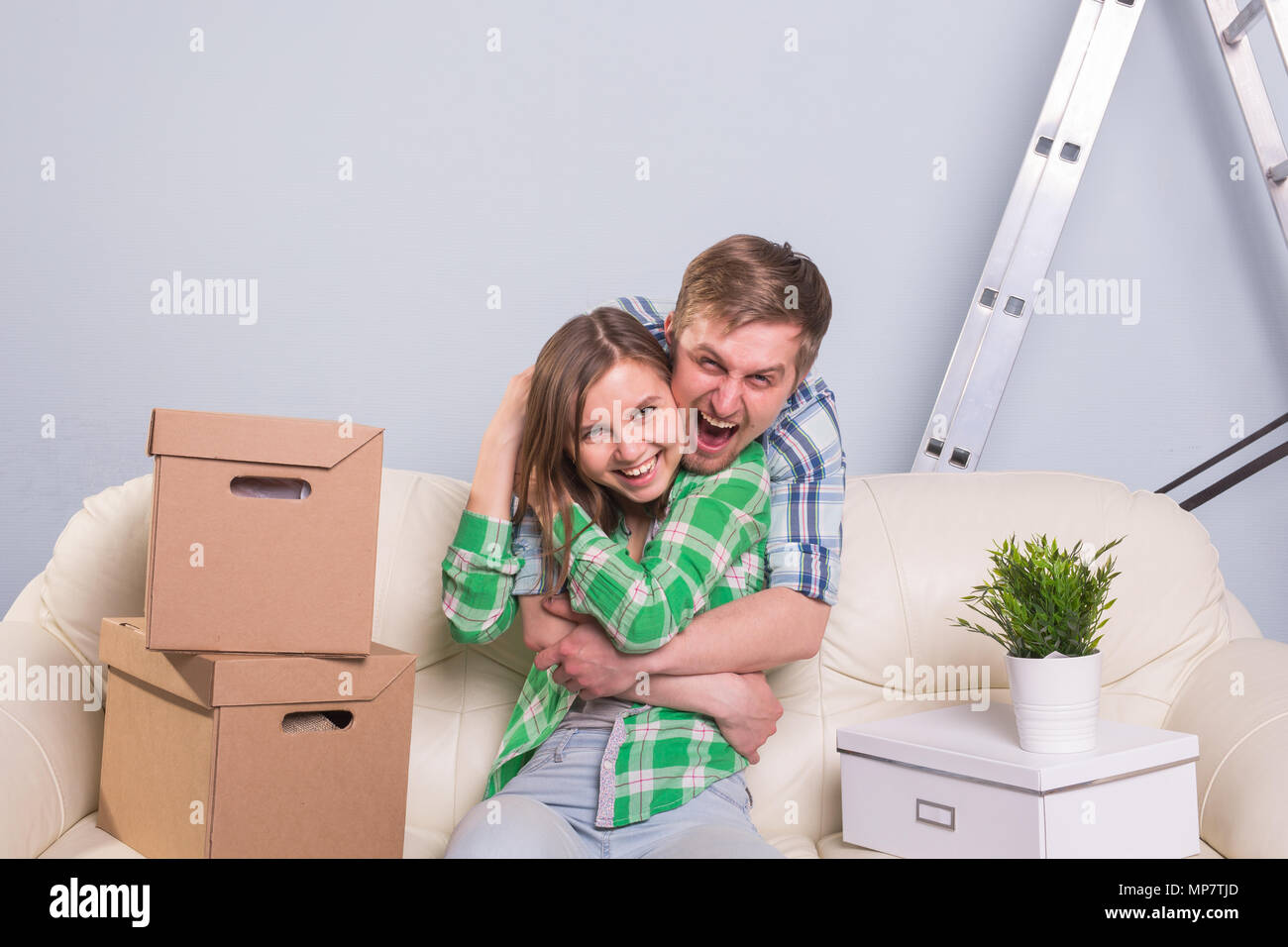 Young cheerful couple moving into their new home Stock Photo - Alamy