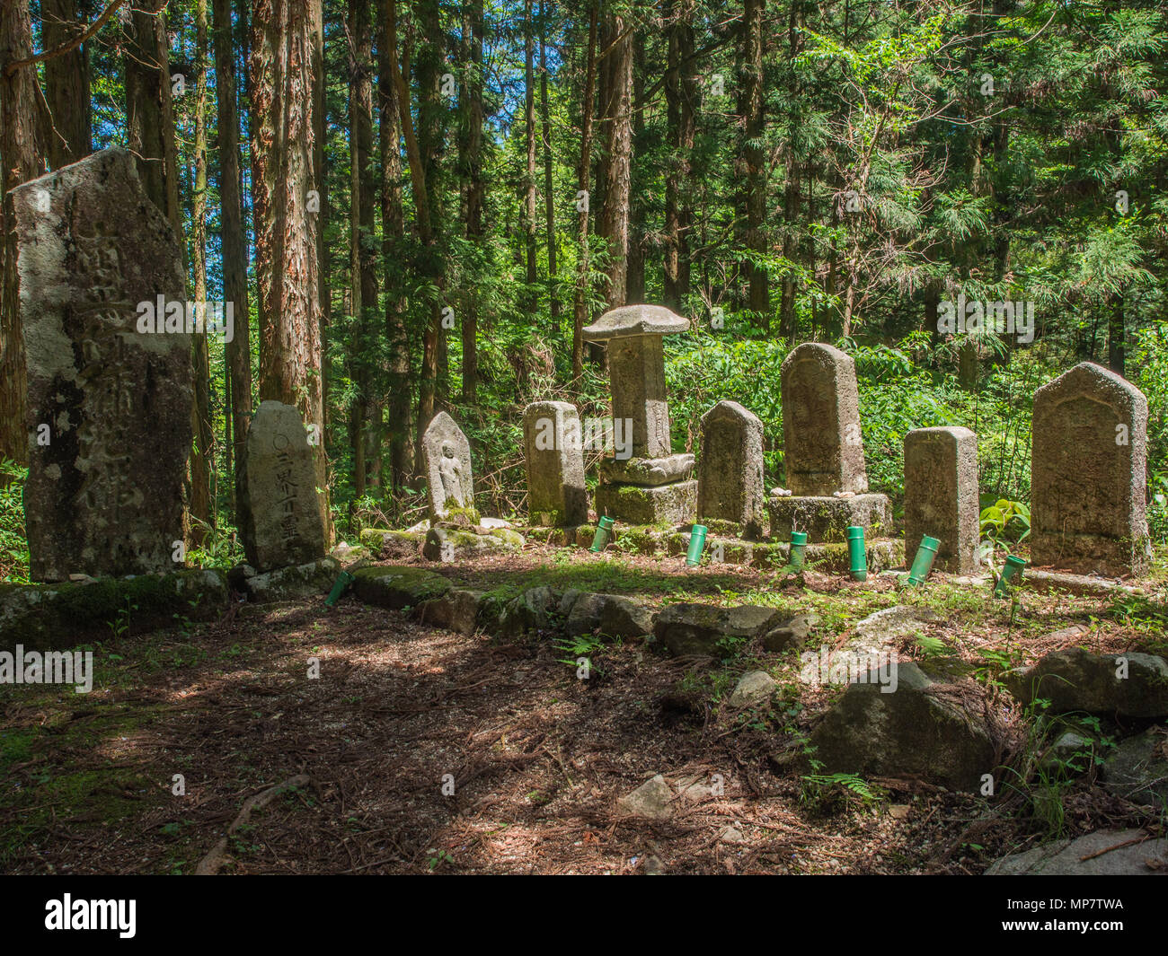 A group of buddhist statues and memorial stones beside Nakasendo highway trail between Magone and Tsumago, Japan Stock Photo