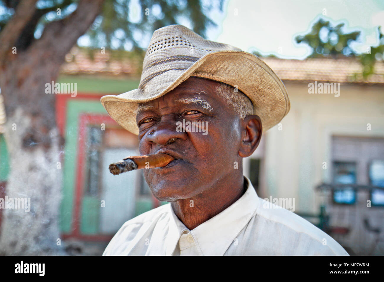 TRINIDAD,CUBA -13 JANUARY:Cuban man smoking a cigar on January 13. 2010.Trinidad,Cuba. Cubans of all ages are actively smoking cigars. All the product Stock Photo